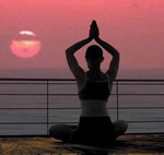 woman doing yoga during sunset