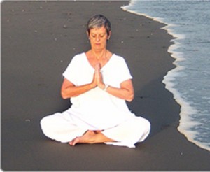 woman practicing meditation at sea beach